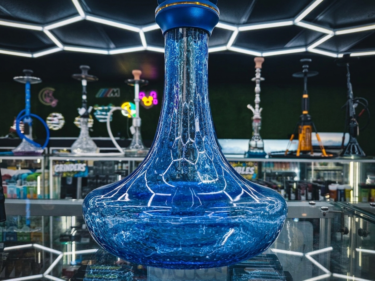 Inside Cloud Smoke Shop — honeycomb-lit ceiling over the glass display cases